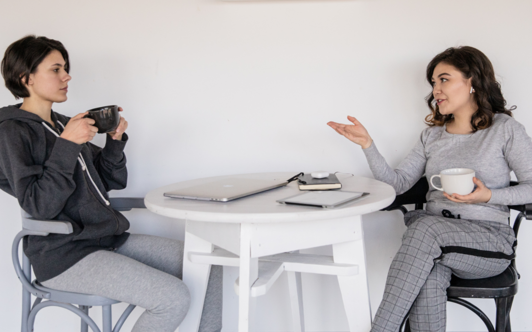 two people discussing mental health stigma at a table with coffee